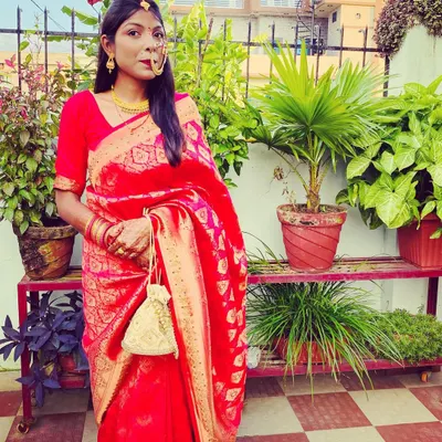This is my take on a traditional 'Pahadi Bahu' or bride look. The classic red saree paired with a gold nath is a timeless combination. I can help you create authentic cultural looks that honor your heritage.