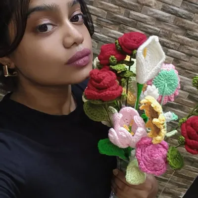 Me with a whole vase full of my forever flowers. This is my happy place, surrounded by all the colorful things I've made.