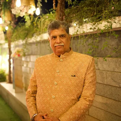 A client looking distinguished and elegant in a golden-beige bandhgala jacket. The subtle pattern and classic cut make this a perfect outfit for the father of the bride or groom, or any guest wanting a regal look.