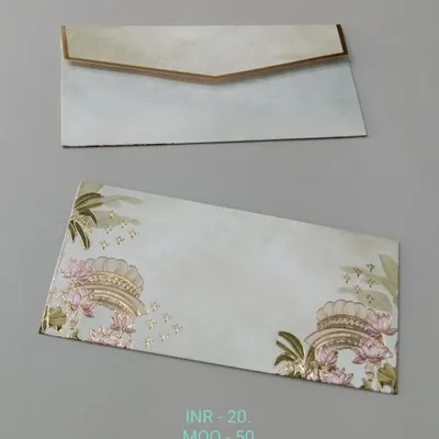A simple and elegant money envelope with a line of pink lotus flowers along the top edge. Gold foil ferns frame the design, and the envelope has a matching gold-lined flap.
