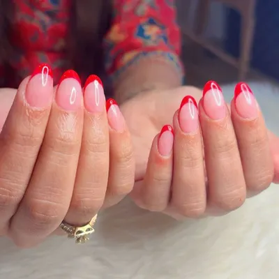 A classic red French manicure is always a good idea. This look features sharp, almond-shaped nails with a sheer pink base and vibrant red tips for a timeless yet bold statement.