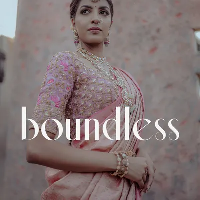 A stunning, magazine-style portrait of a South Indian bride in a pink silk saree. The low-angle shot and her confident pose create a powerful and elegant image.