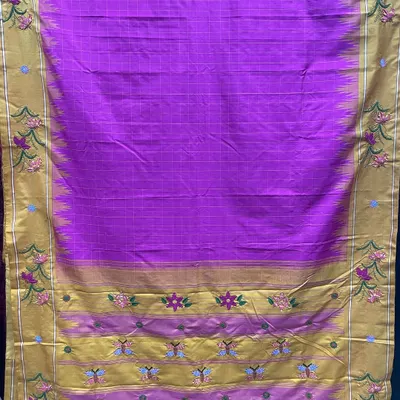 This vibrant magenta Kanjeevaram silk saree was a custom project, brought to life with Kamal Kadai embroidery. The design features floral and butterfly motifs along the golden border, showcasing a traditional weave stitch from Andhra Pradesh and Telangana.