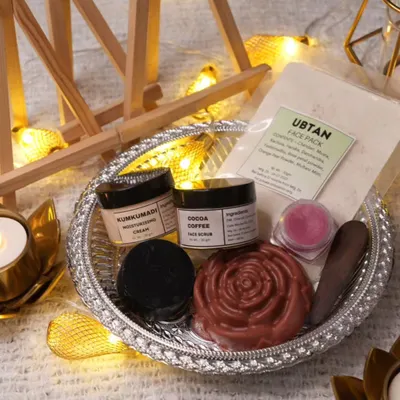 This is our specially curated Diwali Skin Care Kit, featuring a complete regimen of all-natural products. It includes a detoxifying charcoal soap, a moisturizing sandalwood soap, a lip balm, an Ubtan face pack, Kumkumadi cream, and a cocoa coffee scrub to pamper your skin.