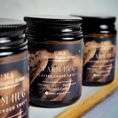 My 'Warm Hug' candle in an amber glass jar, featuring rich notes of coffee and chocolate. This cozy scent is a popular choice for corporate wellness gifts or for creating an inviting atmosphere in cafes and boutiques.