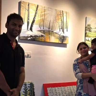 We love seeing our art find its perfect home. Here, a happy family poses with their new landscape painting, a beautiful piece that will bring joy and color to their space for years to come.