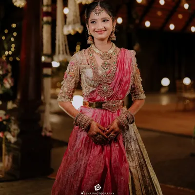 A Langa Voni is a beautiful choice for a half saree ceremony. This young client looks like a doll in her custom pink and gold outfit, featuring a hand-embroidered blouse and a traditional pattu skirt.