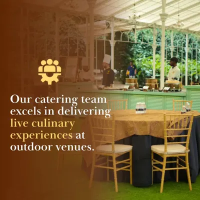 Our catering team excels in delivering live culinary experiences at outdoor venues. Here, our chefs are set up in a beautiful glass-walled pavilion, ready to serve guests fresh and delicious food.