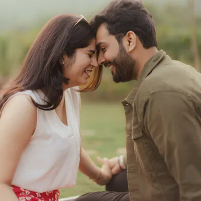 The pure joy of a shared secret. This close-up of the couple touching foreheads and laughing is what our candid photography is all about.