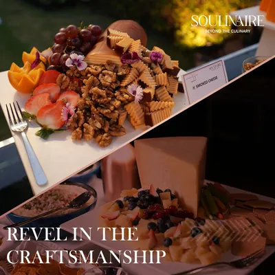 Our grazing platters are a celebration of craftsmanship. This arrangement features smoked cheese paired with fresh strawberries, grapes, and walnuts, garnished with edible flowers for an elegant presentation.