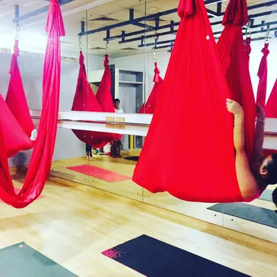 The calm before the storm. Our red silks hanging and waiting for class to begin, ready to support, challenge, and cradle our students.
