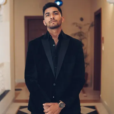 A full-length shot of me dressed in a black suit for a formal event. While I am usually in casual wear, I can dress for any occasion.