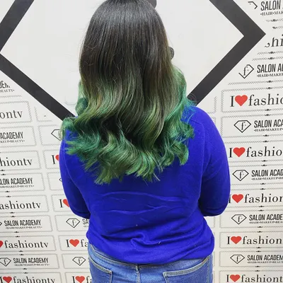 The final result of a creative color transformation. This green balayage with soft waves showcases the skills our students learn in blending, toning, and styling colored hair for a professional finish.