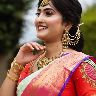 This close-up shows the detail of a flawless makeup application. Notice the smooth skin texture, the soft shimmer on the eyes, and the perfectly defined brows that frame the face.