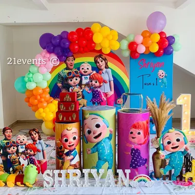 A vibrant and full Cocomelon theme for a first birthday. This setup is packed with characters, a rainbow balloon arch, and a light-up marquee number.