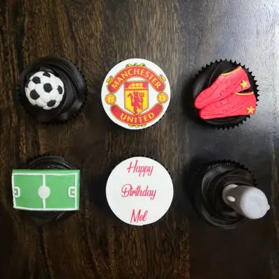 For the ultimate football fan. This Manchester United themed birthday set includes everything from the team crest and a 3D fondant football to edible cleats and a pitch, all on rich chocolate cupcakes.