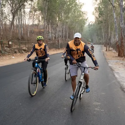 Cyclists enjoying the beautiful, tree-lined roads during our Tour de Forest event. It's a perfect blend of challenging cardio and spectacular scenery.