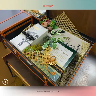 Class meets creativity in our leather suitcase hampers. This open trunk reveals a beautifully arranged selection of gifts, complete with floral accents and a personalized thank you card, perfect for high-end wedding gifting.