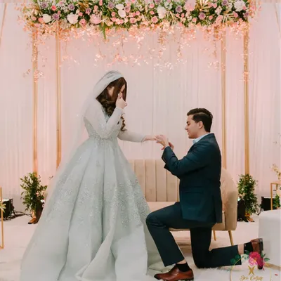A magical proposal moment during an engagement ceremony. I created a simple yet elegant backdrop with a floral-draped arch, allowing the couple's joy to be the main focus.