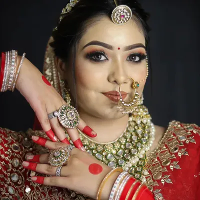 A classic red bridal lehenga paired with soft, glowing makeup. Our students learn to balance tradition with modern techniques for a look that feels both regal and fresh.