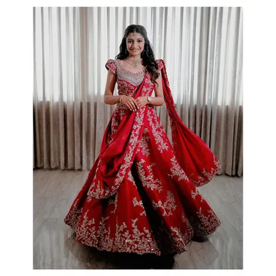 The bride, Ashwini, looking absolutely radiant in her stunning red reception lehenga. The soft, glowing makeup and romantic hairstyle complete her look.