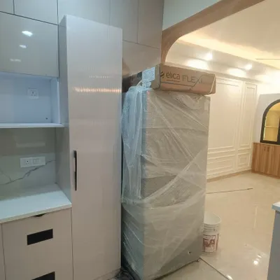 A glimpse of our 3BHK interior project at ATS Rhapsody during the final stages. You can see the newly installed kitchen cabinets and the fridge waiting to be placed.