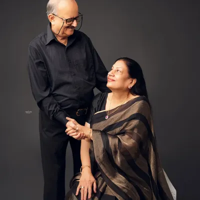 A portrait of enduring love. This elegant older couple shares a sweet, knowing look, beautifully captured in a classic studio setting. It's a privilege to photograph love that has stood the test of time.