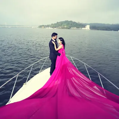 The ultimate fairytale pre-wedding shoot comes to life on a private yacht. This hot pink trail gown is designed for maximum impact, creating a vibrant and unforgettable image that you will cherish forever.