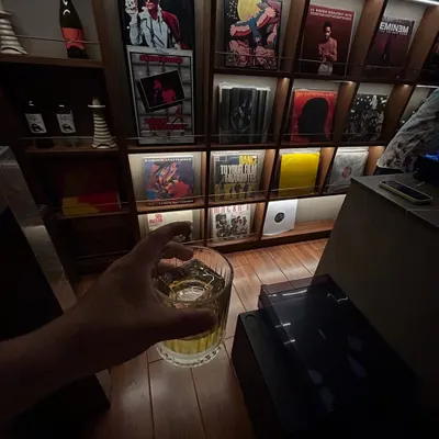 A quiet moment with my vinyl collection. A good drink, and a wall of records featuring artists like Eminem and David Bowie. This is my sanctuary.