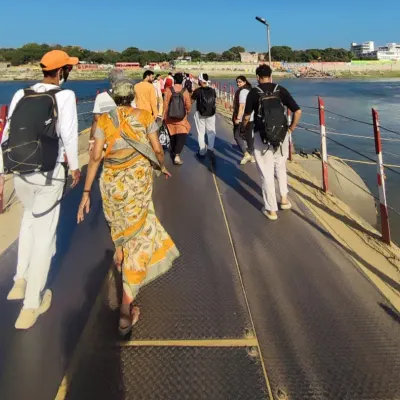 Walking with fellow seekers across a pontoon bridge towards the Sangam during the Kumbh Mela. We move as one body, a river of humanity flowing towards the confluence of sacred waters.