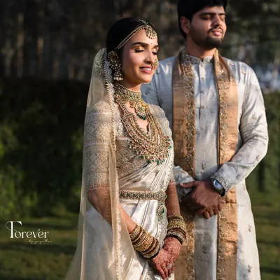A portrait of a bride bathed in golden hour light, showcasing the radiant skin and intricate jewellery of a classic South Indian wedding look.