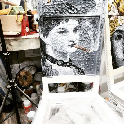 Here's another example of our custom chair painting service. This piece features a monochrome portrait in a classic style, showing how we can adapt our art to different aesthetic preferences, even on complex carved surfaces.