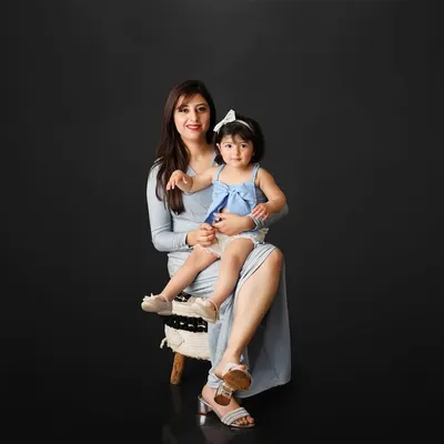 A mother's love is a precious gift. This elegant portrait of a mother and her daughter against a simple black background is a powerful and timeless image of their special bond.