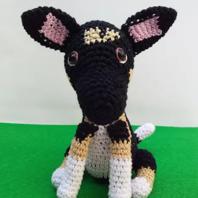 This was a custom order to create a replica of a client's dog. I used different colors of yarn to match the dog's distinct black, tan, and white coat.