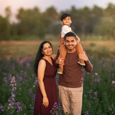 A beautiful family of three, surrounded by a field of purple flowers. This portrait captures the love and happiness of this family, a memory created from a moment of being truly present with each other.