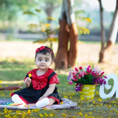 Celebrating the big 'One'. This outdoor first birthday shoot is set against a beautiful park backdrop, using simple props to keep the focus on the birthday girl's sweet and curious nature.