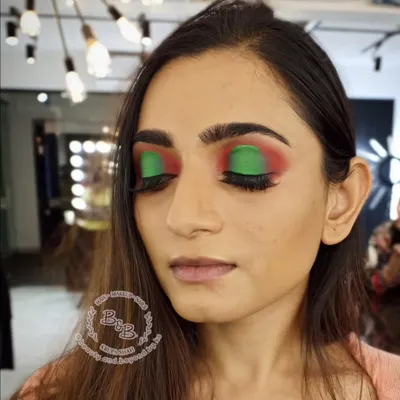 An artistic and colorful halo eye look. Using a vibrant green and red combination, this style is perfect for fashion-forward clients who want to express themselves with bold, popping colors.