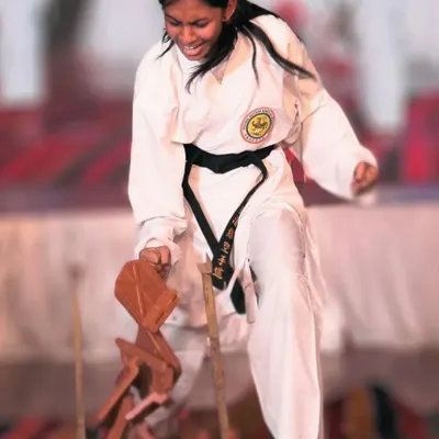 This is the face of determination. Our training empowers every girl to channel her inner strength into powerful, effective techniques, shattering not just boards, but also self-doubt.