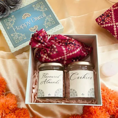 A classic Diwali hamper filled with the essence of the festival. This simple yet elegant box contains jars of flavoured almonds and cookies, and a traditional bandhani potli.