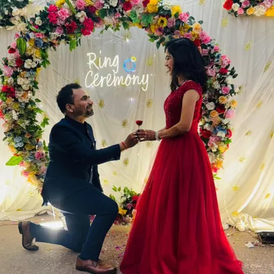 A picture-perfect proposal moment. My classic red ball gown is a stunning choice for a ring ceremony, ensuring the bride-to-be is the center of attention.