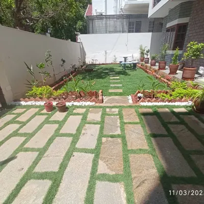 A complete front yard makeover. We installed a lush lawn, a stone pathway, and perimeter garden beds, creating a structured and inviting entrance to the home.