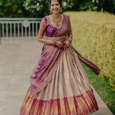A full view of a traditional half-saree (Langa Voni) I designed for a client. The off-white Kanchivaram skirt is paired with a vibrant purple brocade blouse and a draped dupatta.