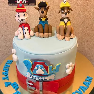 A Paw Patrol cake ready for action. This design features hand-molded, edible figurines of Chase, Marshall, and Rubble on top of a fondant-covered cake.