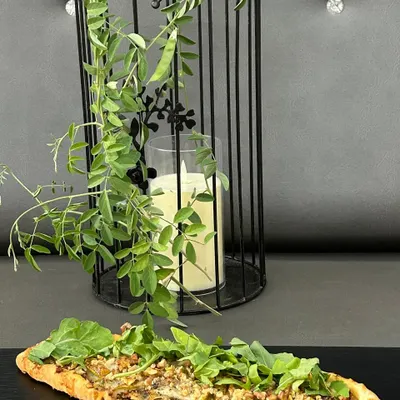 Our Pear & Blue Cheese Flatbread is a sophisticated choice, balancing sweet and savory flavors on a crispy base, topped with fresh arugula.