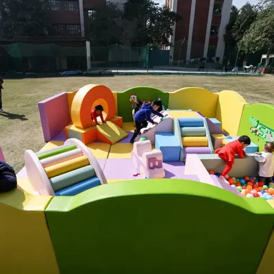 A full view of our colorful soft play area, set up and ready for fun in a spacious outdoor setting. It's a safe and exciting world for kids to explore.