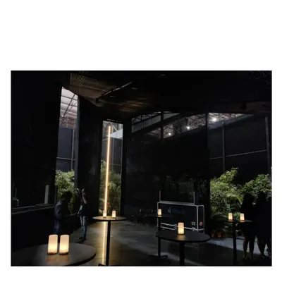 The Durall Pavilion, a black structure designed as a place of pause and peace amidst the cacophony of a product exhibition. It could be a church, a meditation hall, or a garden folly; we designed it to be all of the above.