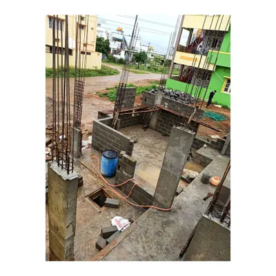 Here you can see our on-site construction work in progress for a residential project in Mysore. This image shows the reinforced concrete columns and foundation work, the literal backbone of the home, which we meticulously supervise for quality and adherence to engineering standards.