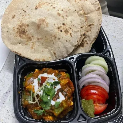 A customer favorite, this thali comes with a rich paneer and capsicum sabzi, three soft whole wheat chapatis, and a fresh salad. It's a satisfying lunch that feels just like home.