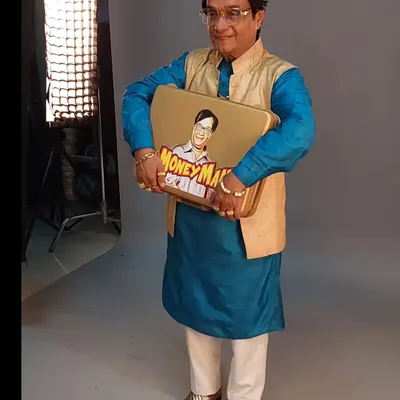 The final look for the 'Money Man' character in a lottery advertisement, played by the wonderful Biju Kalaa. The bright blue kurta, gold waistcoat, and shiny shoes create a fun, aspirational character.