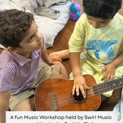 A heartwarming moment from a music workshop where two toddlers explore a ukulele together. Our sessions for the little ones are all about play and discovery.
